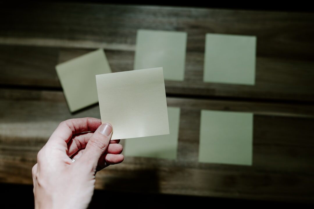 Group of colleagues brainstorming around a table with sticky notes