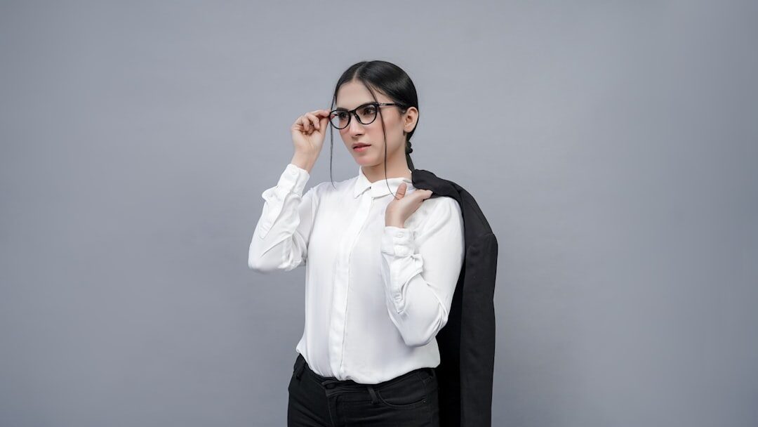 Studio portrait of a young Belgian businesswoman with glasses