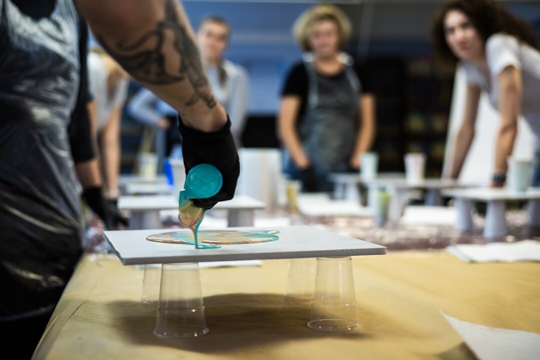 Group of professionals in a workshop discussing around a table
