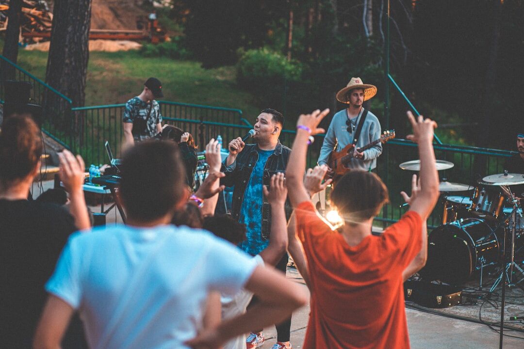 Diverse group of professionals celebrating outdoors with raised arms